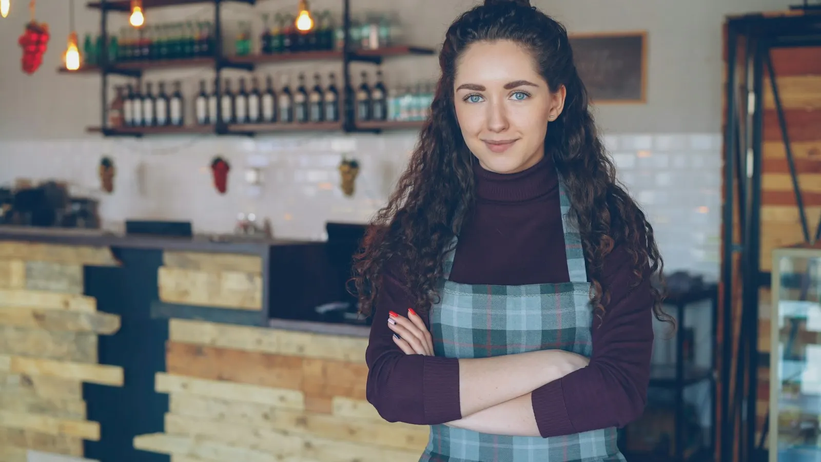 A small business owner standing in her coffee shop