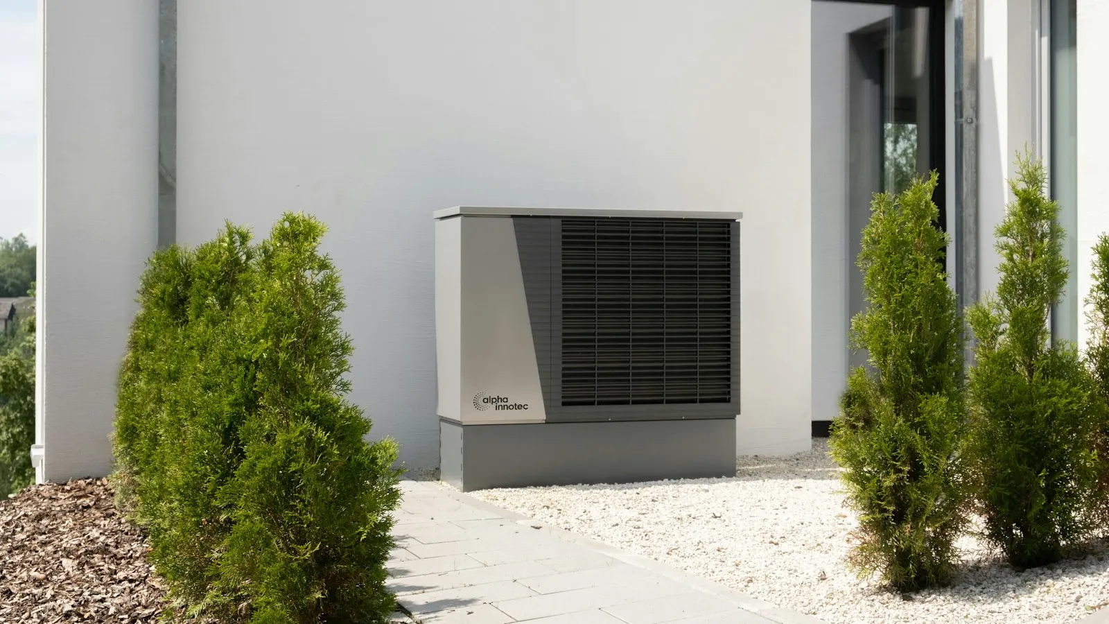 An outdoor heat pump unit beside a modern house