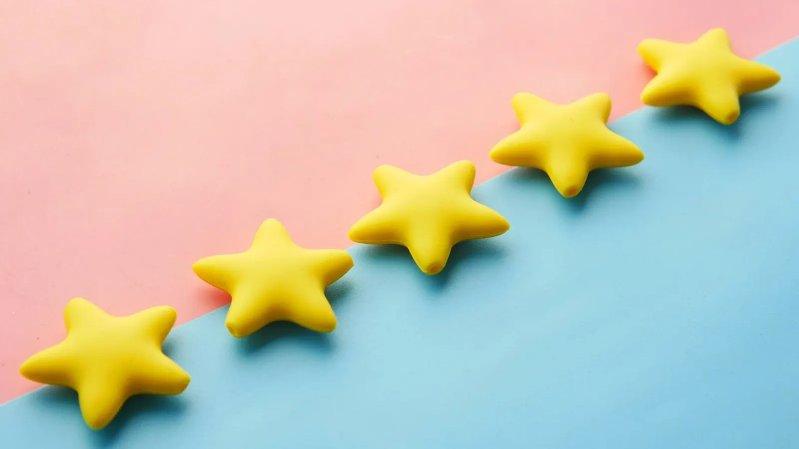 Five yellow stars on a pink and blue background
