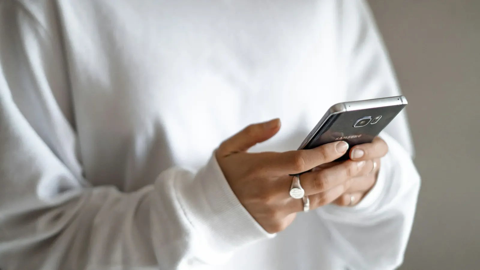 A person reading a text message on a smartphone