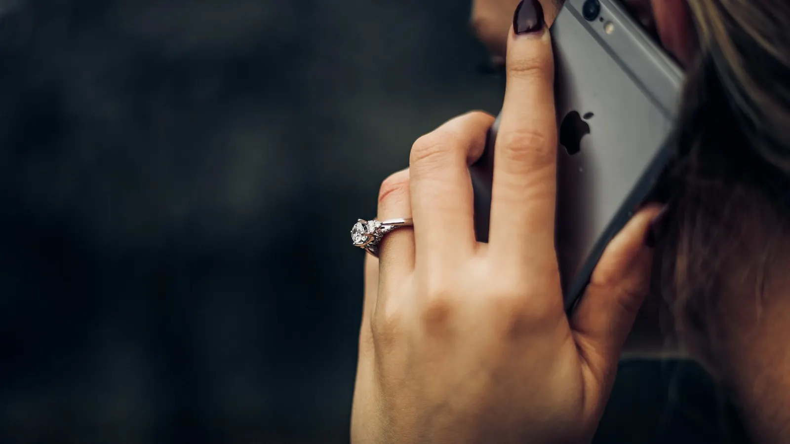 A person holding a smartphone to their ear during a call