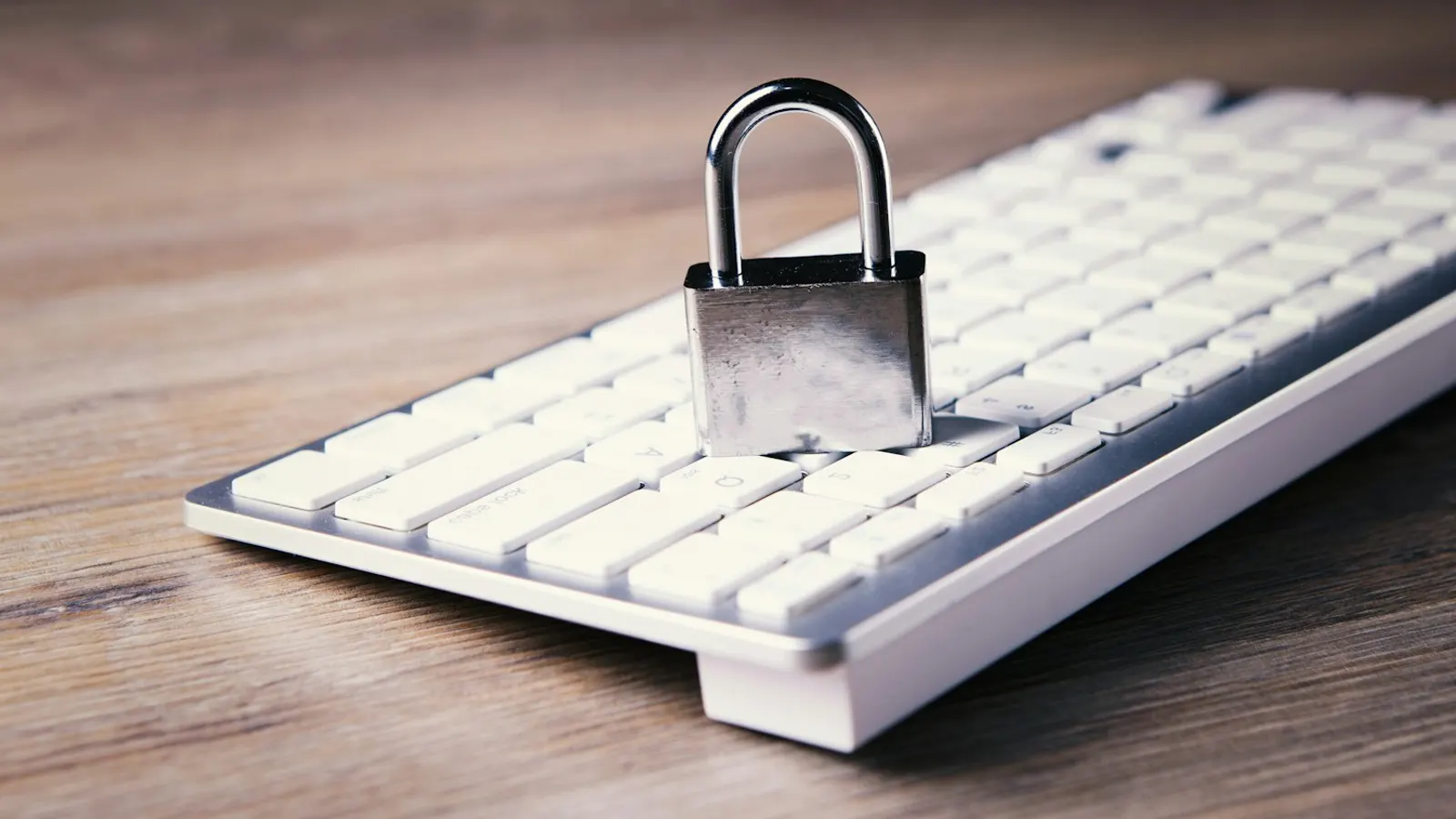 A padlock resting on a computer keyboard