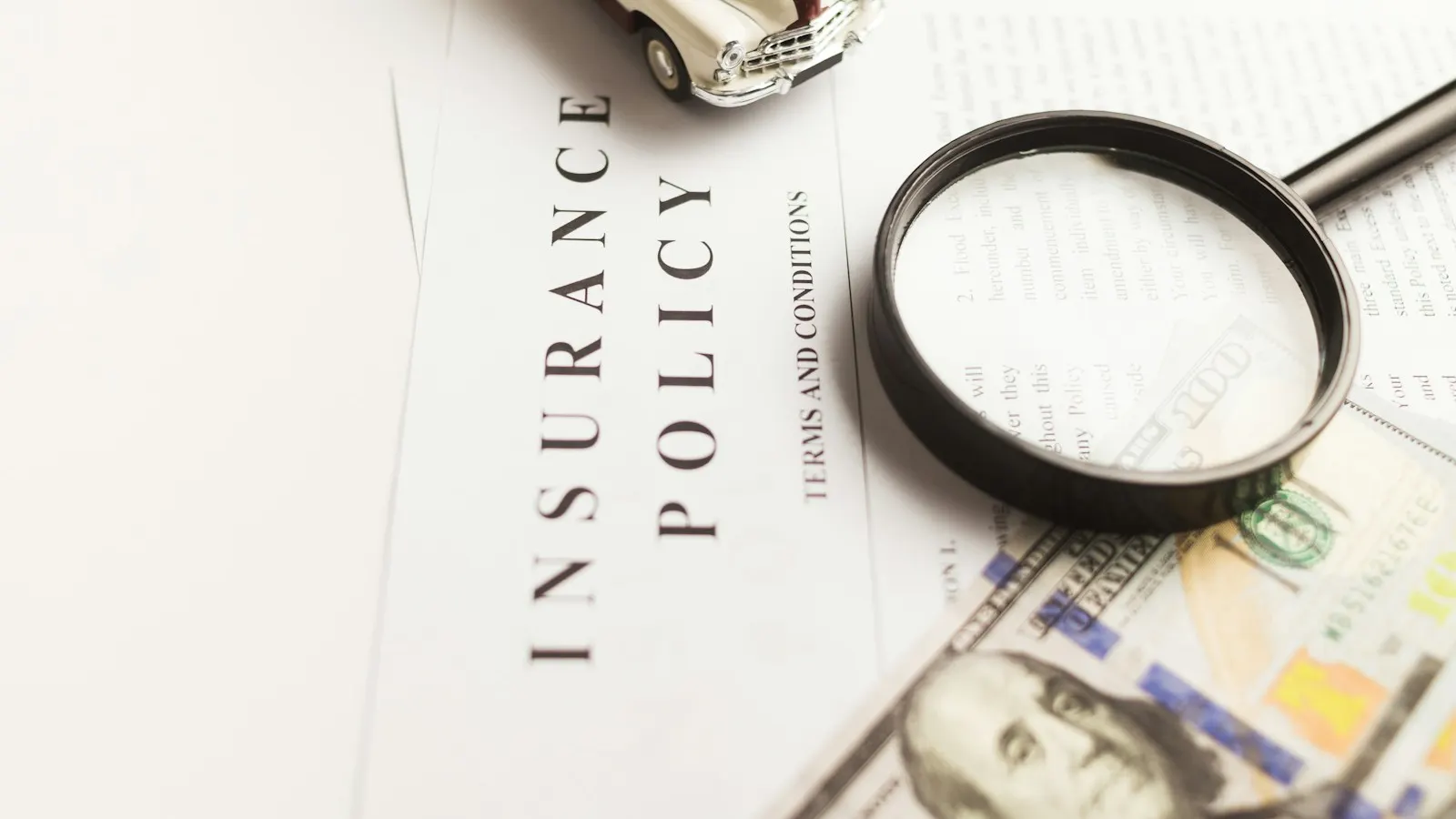 An insurance policy document with a magnifying glass