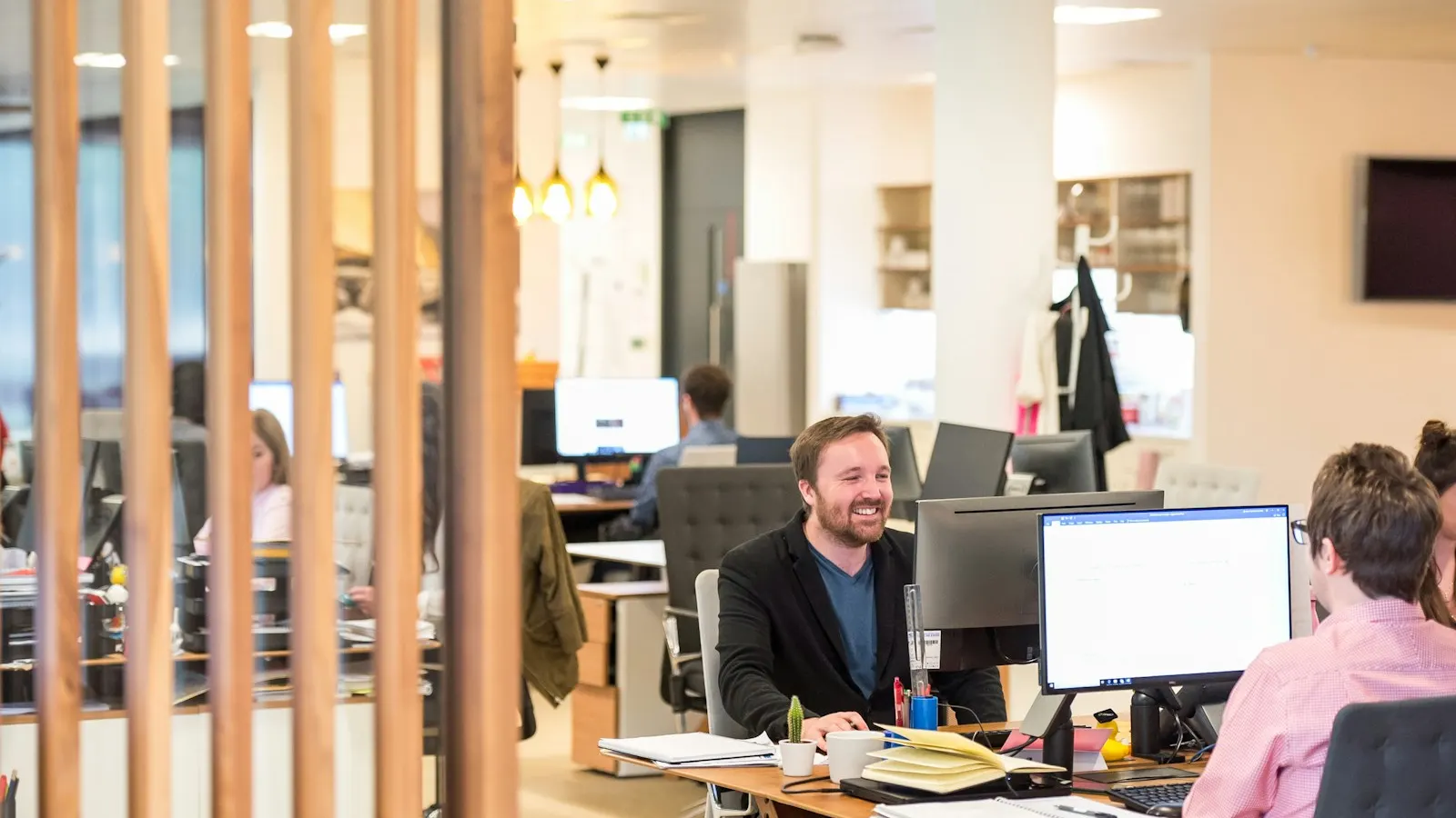 Staff working at desks in an open-plan insurance office