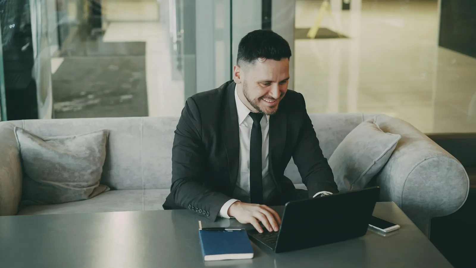 A lawyer in a suit working on a laptop