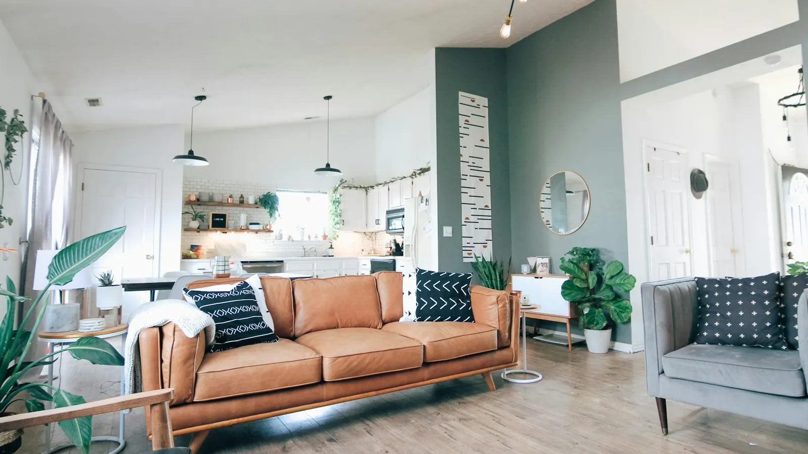A bright, staged living room with a leather sofa