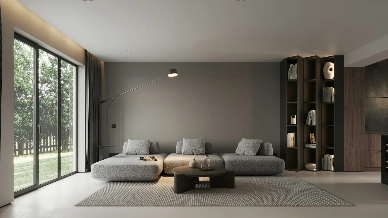 A sparsely furnished modern living room with large windows
