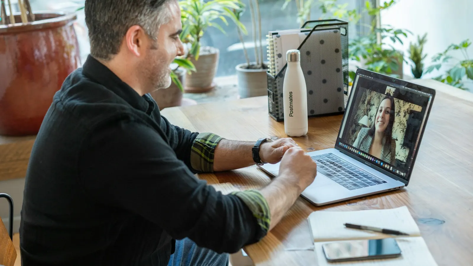 A recruiter on a video interview with a candidate at a laptop